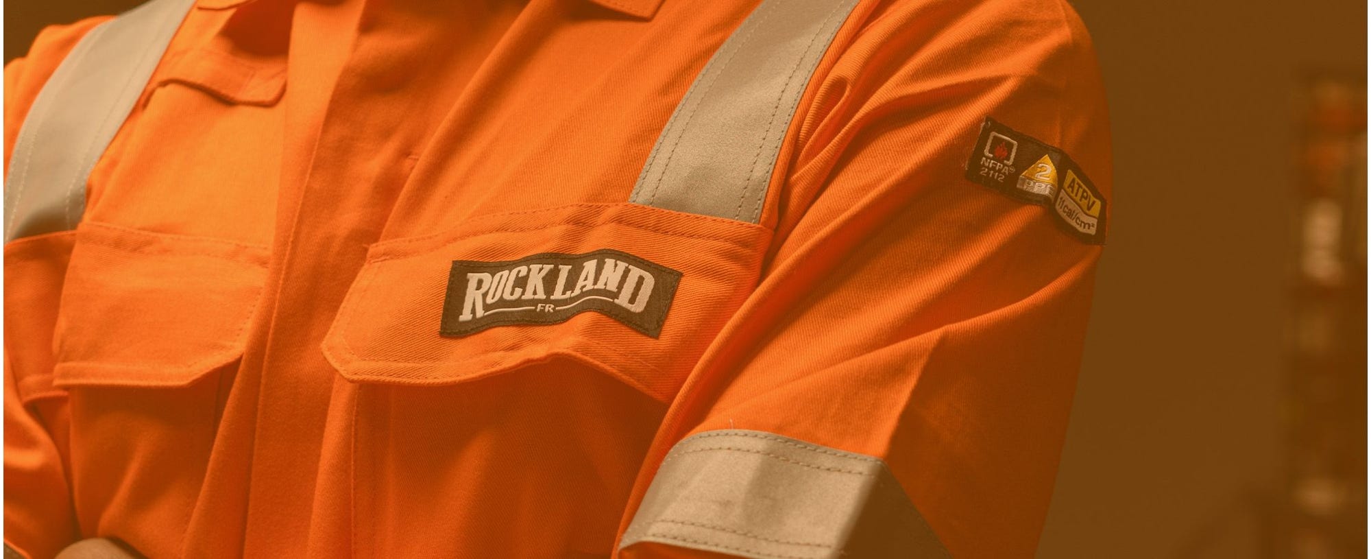 Coveralls with Rockland logo on the  chest and a arc-rated badge on the sleeve