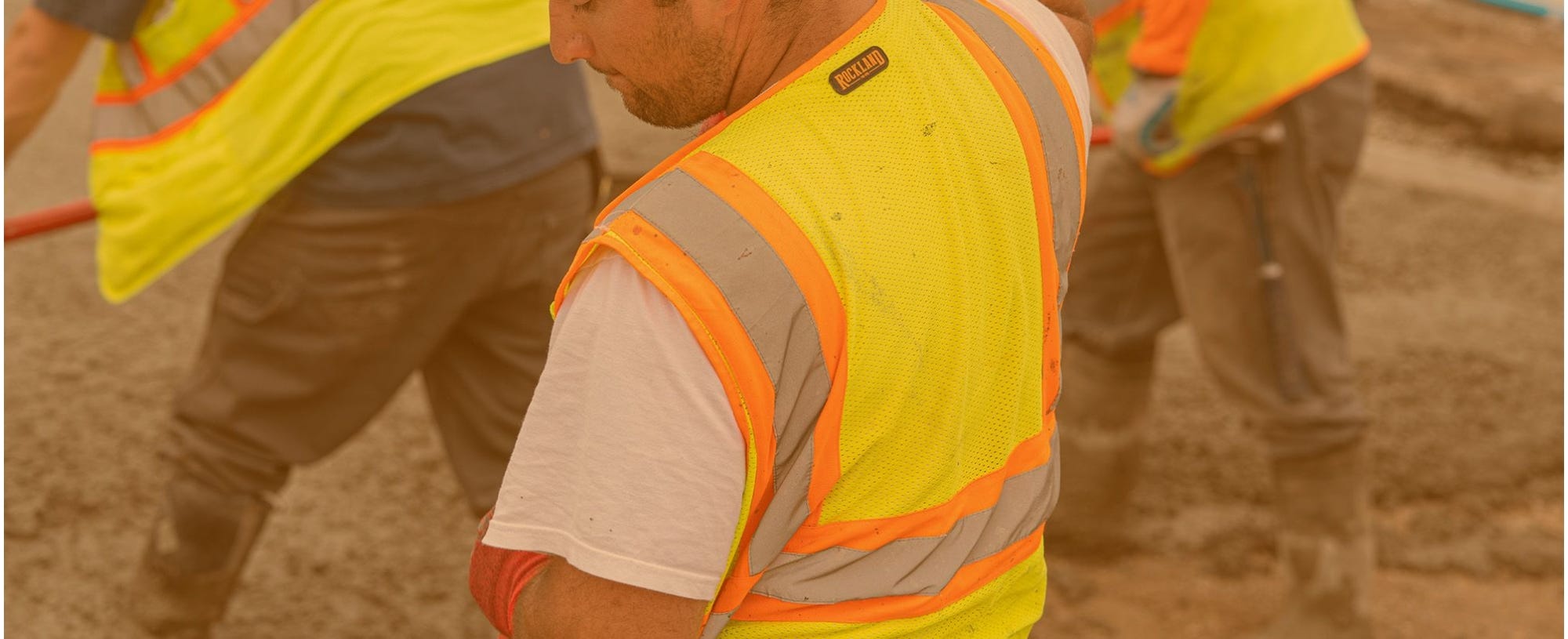 Construction workers wearing vests that say Rockland on the back