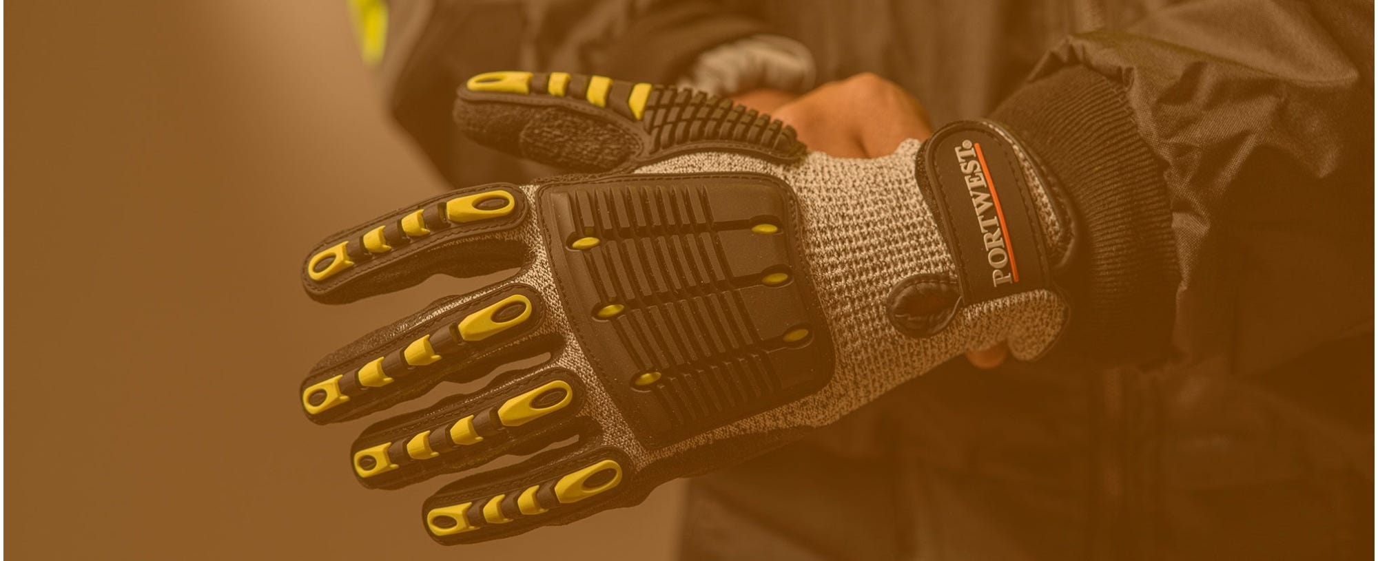 Person wearing impact-rated gloves