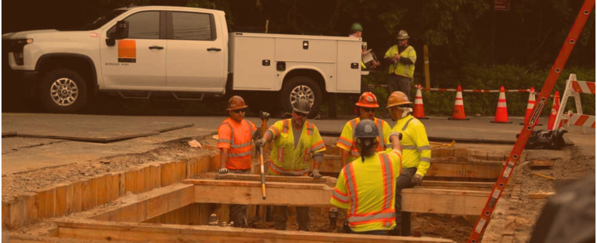 Workers standing in trench