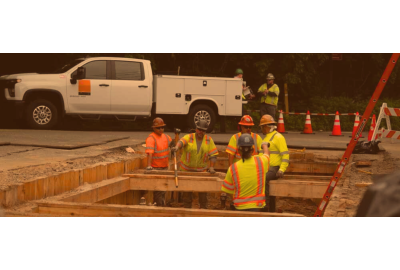 Workers standing in trench